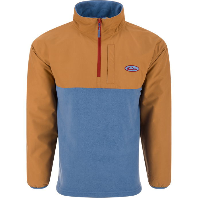 Eqwader Half Zip Pullover featuring a tan, waterproof upper and light blue, breathable fleece lower, with a red zipper and chest pocket, ideal for waterfowl hunting.
