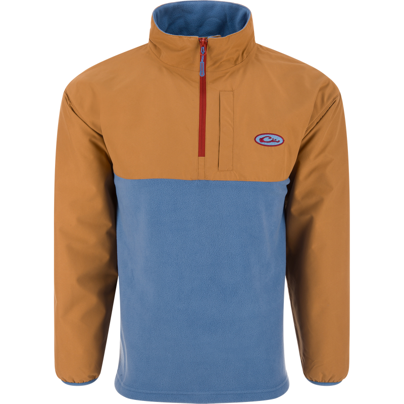 Eqwader Half Zip Pullover featuring a tan, waterproof upper and light blue, breathable fleece lower, with a red zipper and chest pocket, ideal for waterfowl hunting.