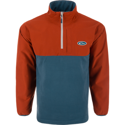 Eqwader Half Zip Pullover with rust-orange waterproof upper and teal breathable lower, featuring a short zip, elastic cuffs, and chest logo. Ideal for waterfowl hunting.