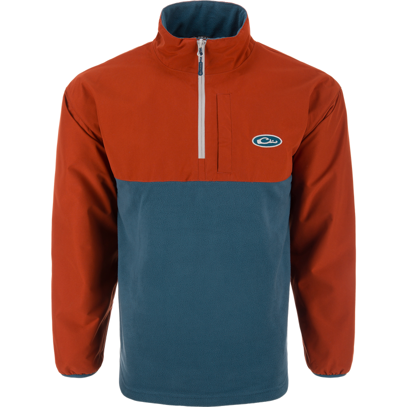 Eqwader Half Zip Pullover with rust-orange waterproof upper and teal breathable lower, featuring a short zip, elastic cuffs, and chest logo. Ideal for waterfowl hunting.