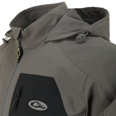 Close-up of the Rain Brake Lightweight Softshell Jacket featuring adjustable hood, YKK zippers, and water-resistant fabric, highlighting its functional design for outdoor activities.
