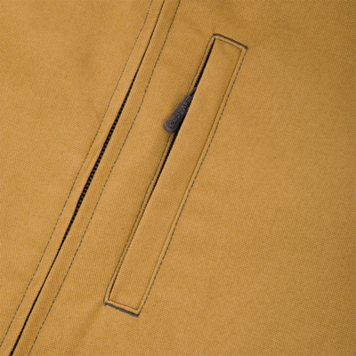 Close-up of a tan Canvas Sherpa Lined Work Vest featuring a vertical zippered chest pocket with a branded pull tab.
