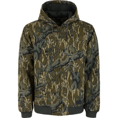 Lifestyle Duck Canvas Work Jacket in a Mossy Oak Original Treestand camouflage pattern, featuring a zip-up hood, insulation, and black rib-knit cuffs and hem.