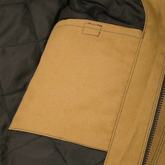 Close-up of the interior of a Duck Canvas Work Jacket showing a tan rectangular pocket stitched onto a quilted dark lining.