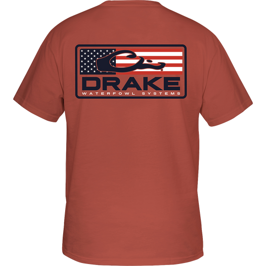 Patriotic Bar T-Shirt: Back view of a red shirt with the Drake Logo overprint, featuring an American Flag design. Front left chest pocket with the Drake Waterfowl logo. Premium quality cotton or cotton-polyester blend. Lightweight at 180 GSM. Final Sale.