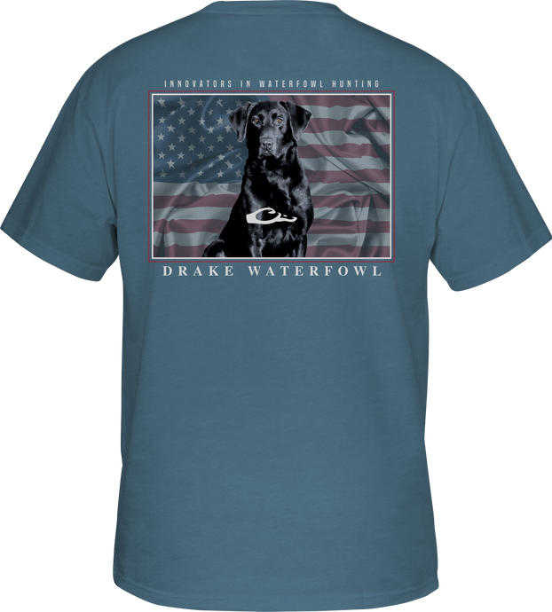 A blue shirt with a dog and an American flag overprint, featuring the Drake logo pocket on the front - Americana Lab T-Shirt.