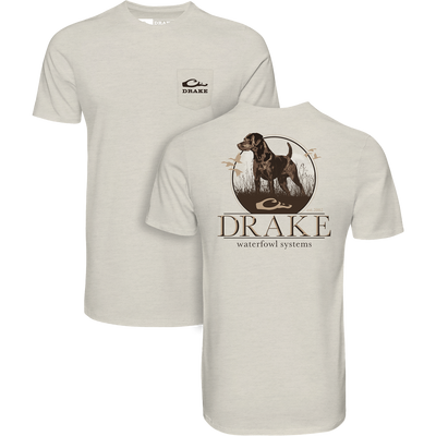 Standing Black Lab T-Shirt featuring a chest pocket with Drake logo and a back graphic of a hunting dog with ducks, highlighting Drake Waterfowl's hunting heritage.