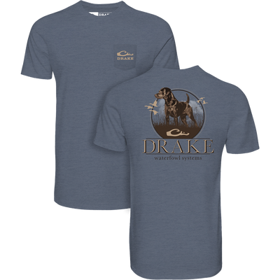 Standing Black Lab T-Shirt featuring a pocket with Drake logo and a back graphic of a Labrador in marsh, ideal for waterfowl enthusiasts.