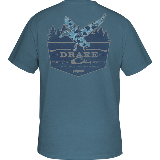Old School In-Flight T-Shirt from Drake Waterfowl: Blue shirt with bird and tree design, featuring a Drake logo chest pocket. 60% cotton, 40% polyester blend for style and comfort.