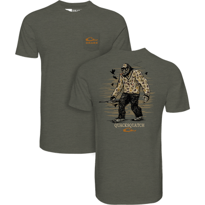 Quacksquatch T-Shirt by Drake features Bigfoot in camo with a shotgun and ducks, plus orange Drake logo, offering comfort in a cotton-poly blend.