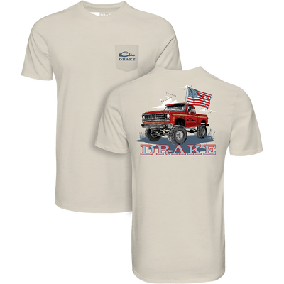 Americana Flag Truck T-Shirt featuring a front pocket with DRAKE logo and back graphic of a truck with an American flag. Lightweight, ideal for casual wear.