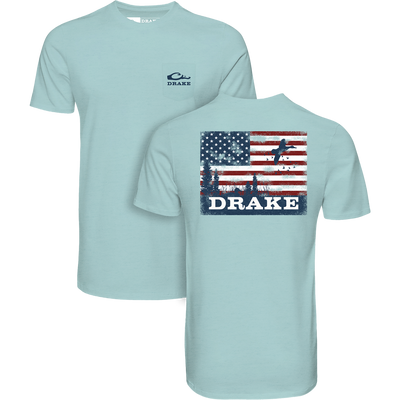 Americana Scenic Flag T-Shirt with front pocket Drake logo; back features distressed American flag with marsh, trees, flying ducks, and bold DRAKE text.