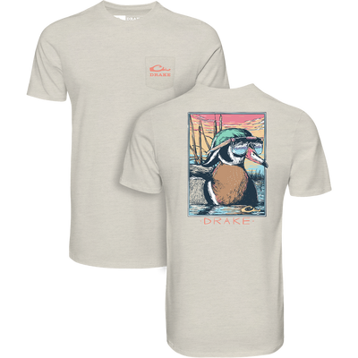 Pop Art Wood Duck Sunglasses T-Shirt featuring a chest pocket with Drake logo and a vibrant back illustration of a wood duck in aviator goggles at sunset.