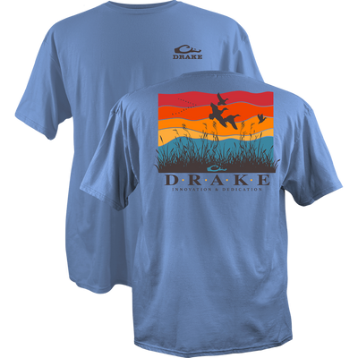 Flyway Sunrise Cotton T-Shirt features a waterfowl-themed graphic with duck silhouettes and marsh grasses, DRAKE branding on the front and back, crafted from soft, garment-washed cotton.