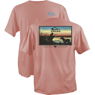 Dedication Innovation T-Shirt featuring Drake logo on front and sunset marsh hunting scene graphic with dog and birds on back, crafted from soft, garment-washed cotton.
