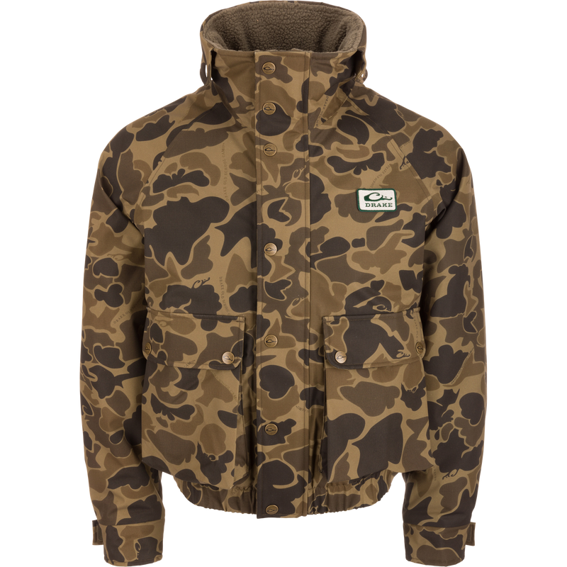 Throwback 80 Insulated Sport Bomber Jacket with camouflage pattern, high collar, snap-front, and “Drake” logo patch, featuring flap pockets and zoned insulation for warmth.