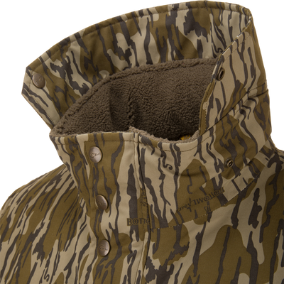 Throwback 80 Insulated Sport Bomber Jacket featuring a camouflage-patterned shell, fleece-lined interior, and metal snap buttons on the collar for warmth and protection.