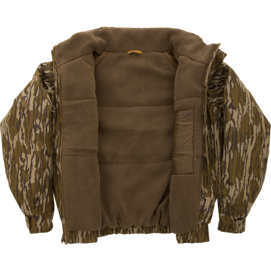 Throwback 80 Insulated Sport Bomber Jacket with camo exterior and brown sherpa fleece lining, featuring large accessory pockets, flip-up collar, and adjustable cuffs.