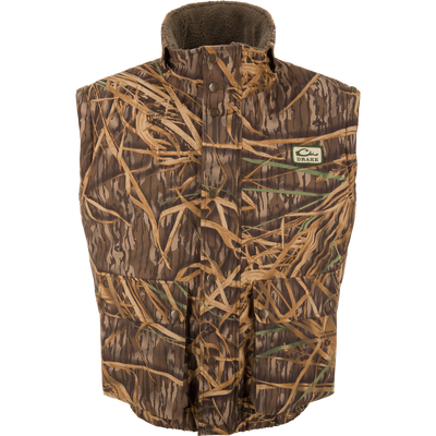 Drake's Throwback 80 Sport Vest, sleeveless camo with snap-front, features large pockets, high collar, and fleece lining for warmth, ideal for outdoor hunting adventures.