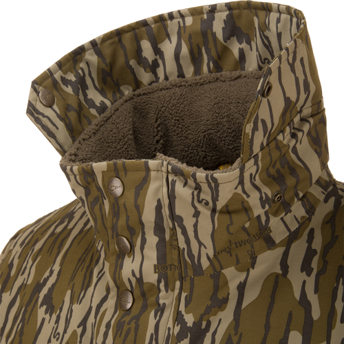 Close-up of the Throwback 80 Sport 3-in-1 Jacket's collar, showcasing tiger-stripe camo pattern, fleece lining, and metal snap buttons for outdoor versatility.