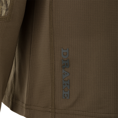 Close-up of BMF EST Offset 1.0 Crew's brown waffle-knit side, showcasing grid texture, camo insert, seams, and part of vertical logo, emphasizing performance features.