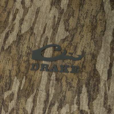 Close-up of Drake's BMF EST Offset 1.0 Crew logo on camouflage fabric, highlighting performance-focused design for hunting, with advanced cooling and moisture-wicking technology.