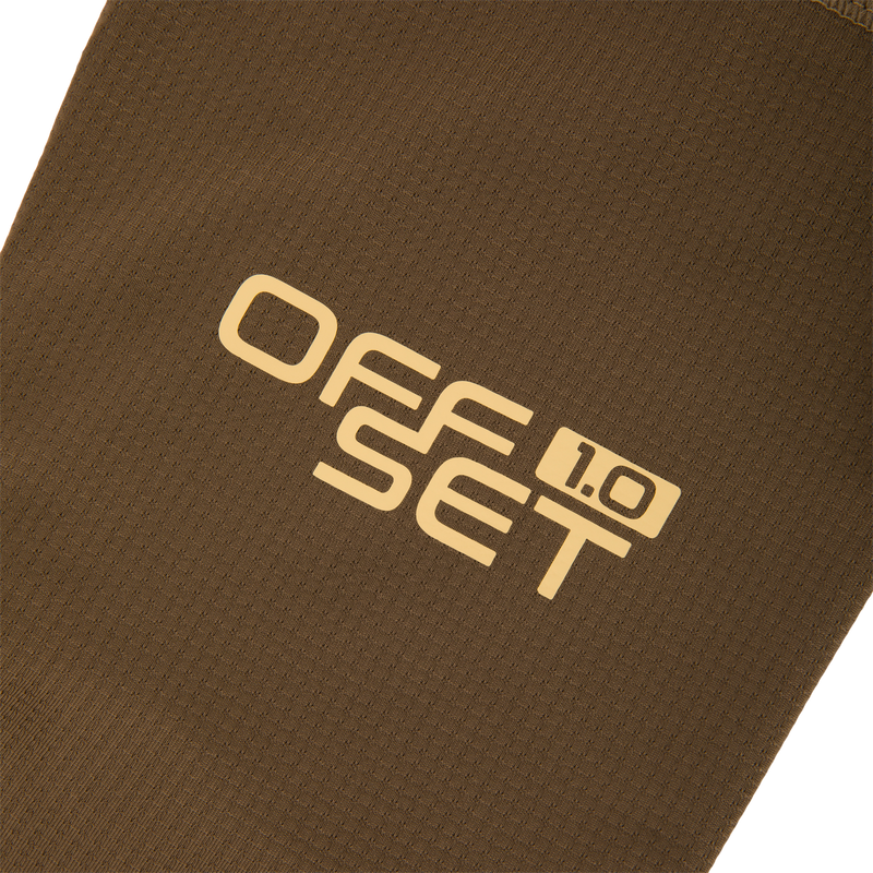 Close-up of the EST Offset 1.0 Half Zip Pullover's brown waffle-knit fabric, showcasing OFFSET 1.0 in pale yellow, highlighting its comfort and breathability features.