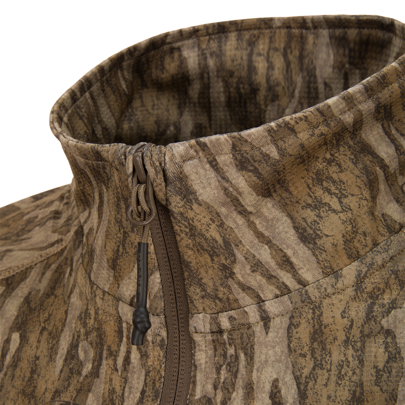 EST Offset 1.0 Half Zip Pullover features a high collar with central zipper, wood-grain camo print, ideal for hunting with ergonomic thumbholes for functionality.