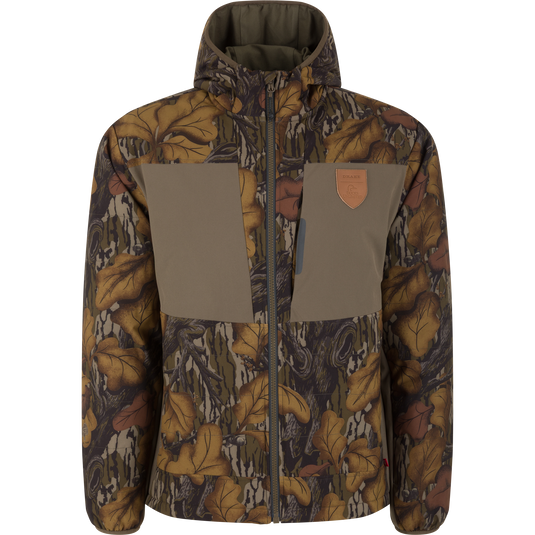 Drake X Ducks Unlimited LST BMF Jacket with Primaloft featuring a Mossy Oak Fall Foliage camouflage pattern, a solid olive chest panel with a leather-style logo patch, and insulation.