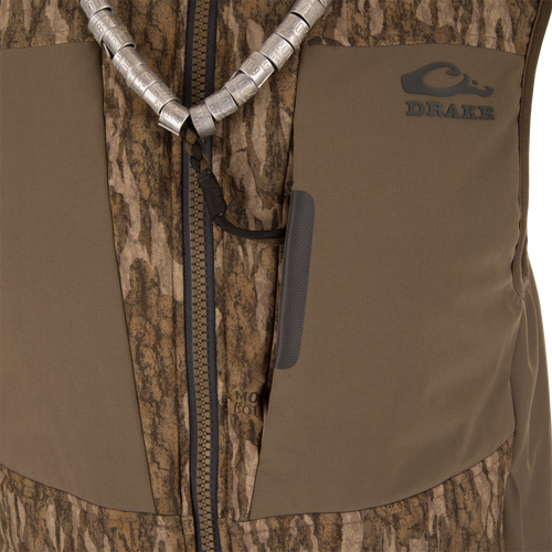 LST BMF Vest with Primaloft features a brown camo pattern, sturdy zipper, and a braided lanyard with goose call tubes, ideal for hunting layers.