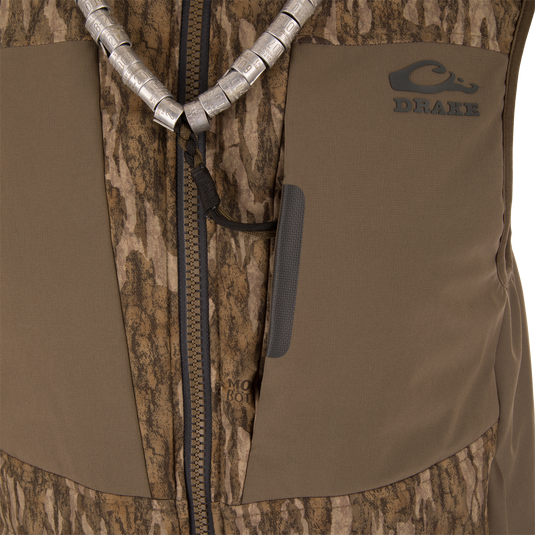 LST BMF Vest with Primaloft features a brown camo pattern, sturdy zipper, and a braided lanyard with goose call tubes, ideal for hunting layers.
