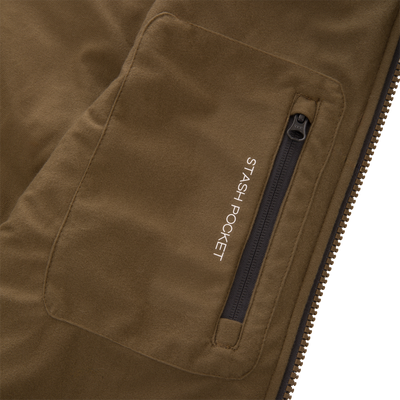 Close-up of the LST BMF Vest with Primaloft, highlighting the stash pocket with a black zip closure, emphasizing its functional design for versatile layering.