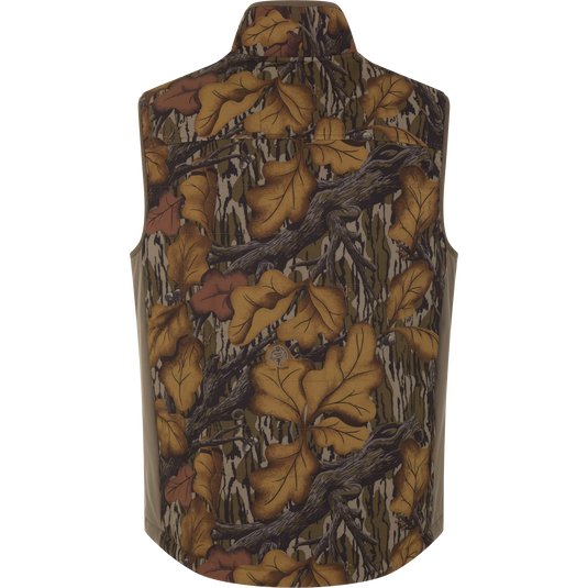 Back view of a Drake X Ducks Unlimited LST BMF Vest with Primaloft featuring a brown and green camouflage pattern of oak leaves and branches.