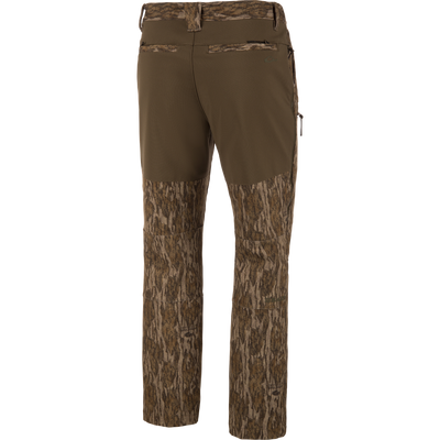 MST CommandXT Softshell Pant with bark-style camo and olive waistband, featuring belt loops, rear welt pockets, and zippered side pocket for outdoor activities.