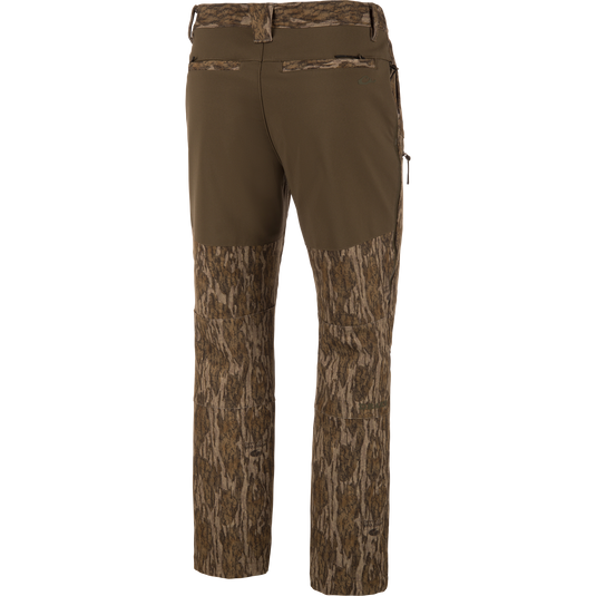 Back view of olive green MST Youth CommandXT Softshell Pant featuring a stretch waistband and camouflage print on the lower legs and seat.