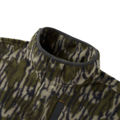Close-up of the Camp Fleece Limited Edition Snap Pullover, showcasing its tiger-stripe camouflage fleece texture, stand-up collar, and Magnattach chest pocket detail.