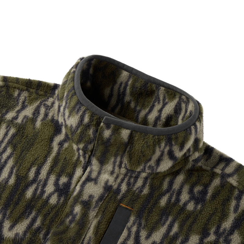 Close-up of the Camp Fleece Limited Edition Snap Pullover, showcasing its tiger-stripe camouflage fleece texture, stand-up collar, and Magnattach chest pocket detail.