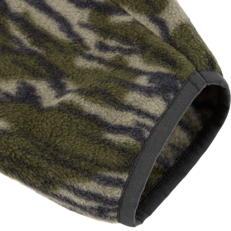 Close-up of the Camp Fleece Limited Edition Snap Pullover's sleeve in tiger-stripe camo, showcasing soft fleece texture and solid dark binding.