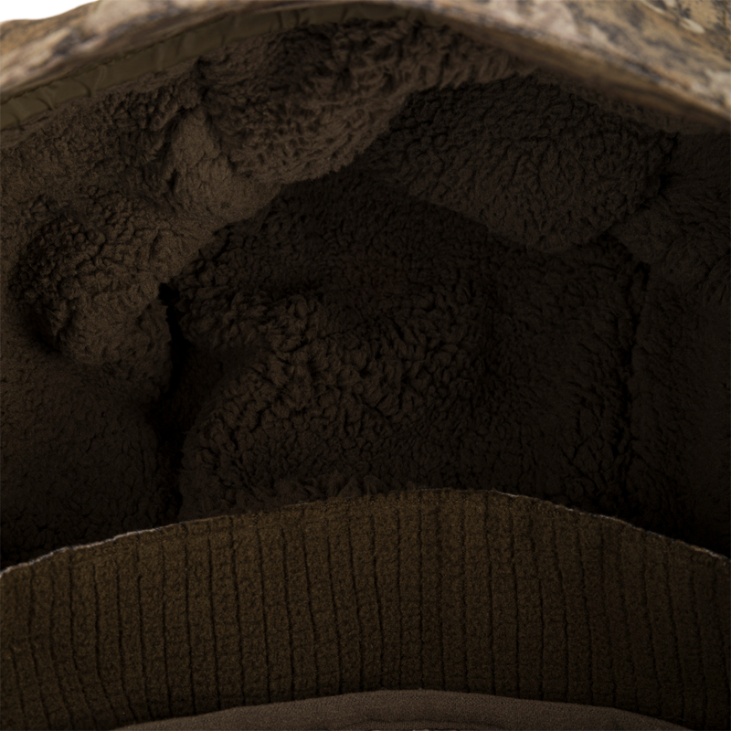 Close-up of LST CommandXT 3-in-1 PrimaLoft Insulated Jacket showcasing plush brown sherpa lining and rib-knit trim, highlighting its warmth and comfort features.