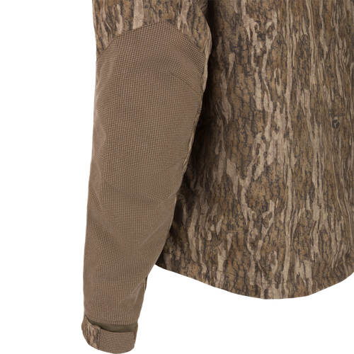 Camouflage CommandXT 3-in-1 PrimaLoft Insulated Jacket on mannequin, highlighting grid-textured elbow panel, Velcro cuff, exemplifying rugged, versatile hunting gear.