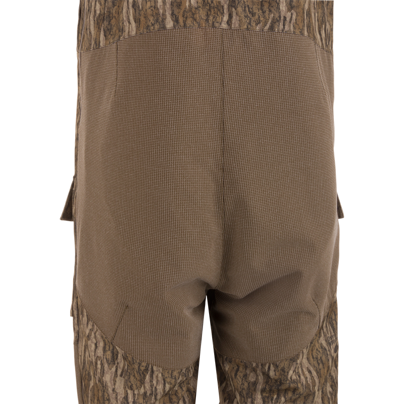 Close-up of the LST CommandXT Bib with Primaloft, showing reinforced grid-weave fabric over the seat area and cargo pocket flap, highlighting durability and functionality.