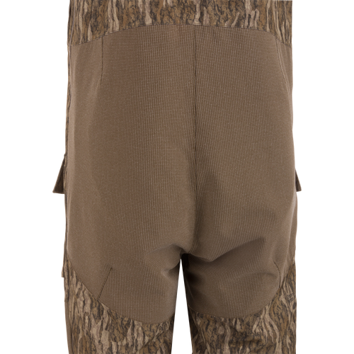 Close-up of the LST CommandXT Bib with Primaloft, showing reinforced grid-weave fabric over the seat area and cargo pocket flap, highlighting durability and functionality.