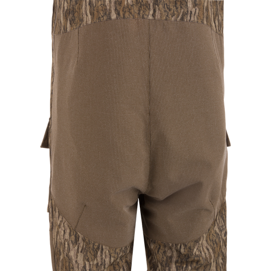 Close-up of the LST CommandXT Bib with Primaloft, showing reinforced grid-weave fabric over the seat area and cargo pocket flap, highlighting durability and functionality.