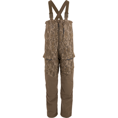 LST CommandXT Bib with Primaloft, featuring camouflage design, adjustable suspenders, multiple pockets, and front zipper; ideal for blending into woodland hunting environments.