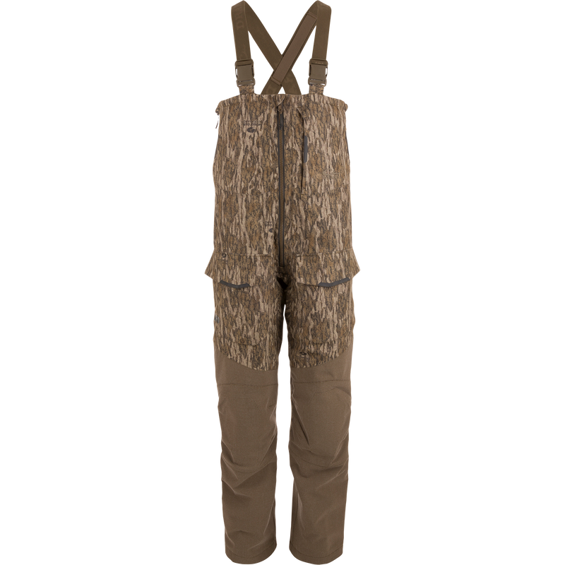 LST CommandXT Bib with Primaloft, featuring camouflage design, adjustable suspenders, multiple pockets, and front zipper; ideal for blending into woodland hunting environments.
