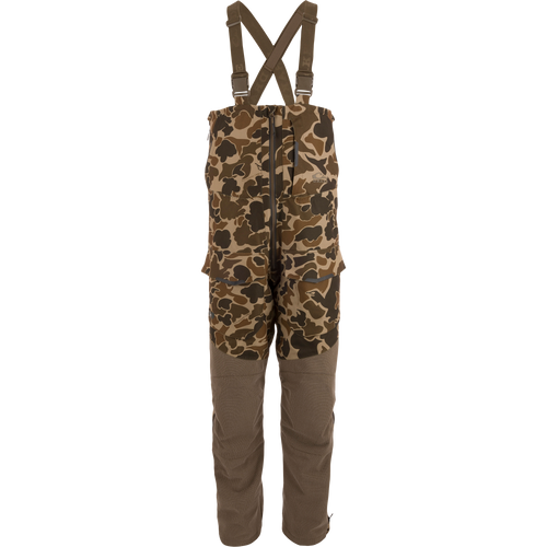 LST CommandXT Bib with Primaloft features camouflage pattern, adjustable suspenders, reinforced legs, and multiple cargo pockets, ideal for extreme outdoor conditions and hunting.