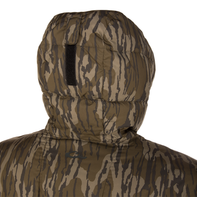 Close-up of the BMF Down Jacket's hood with tiger-stripe camo, highlighting quilted stitching and Velcro loop, designed for warmth and durability in harsh hunting conditions.