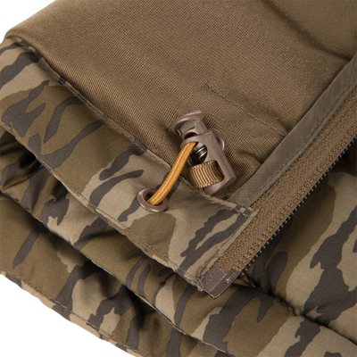 Close-up of the BMF Drake Down Vest's camo quilted shell, showcasing stitched seams, grommeted drawcord, and plastic toggle, highlighting its rugged, insulating design for hunting.