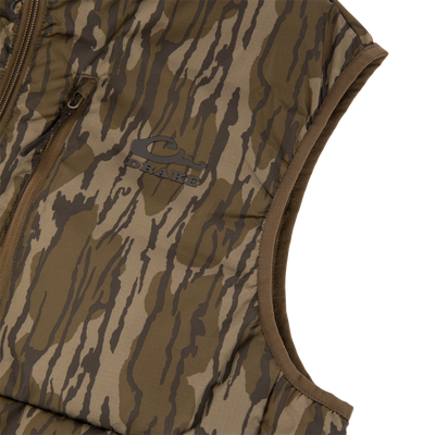 BMF Drake Down Vest, featuring a camouflage pattern, quilted design, and zippered pocket, ideal for layering in hunting conditions for warmth and mobility.