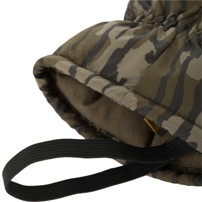 Close-up of LST Down Lobster Mitten's camo-print quilted fabric with black nylon strap, showcasing rugged design and insulating fleece lining for cold-weather hunting.